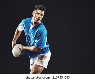 Time for a try. Studio shot of a rugby player passing the ball against a black background. - Powered by Shutterstock