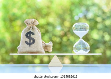 Time value of money, asset growth over time, financial concept : Dollar bags, sand clock or hourglass on a balance scale in equal position, depicts investment in long-term equity for more money growth - Shutterstock ID 1315892618