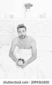 Its Time To Wake Up From Dream. Sexy Man Wake After Sleep. Handsome Guy Hold Clock In Bed. Wake Up To Alarm Clock Signal. Wakeup Service. Good Morning. Early Time. New Day