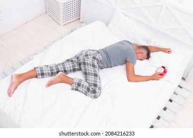 Time to wake up. Man handsome guy lay in bed with alarm clock. Get enough amount of sleep. Tips sleeping better. Bearded man sleeping relaxing on pillow. Pleasant relaxation concept. Sleeping hours