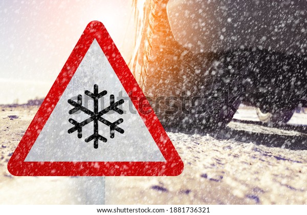 Time for winter tires - tire in winter
with a traffic sign. It emphasizes the importance of snow tires.
There is a snow symbol on the traffic
sign.