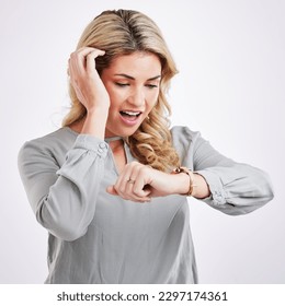 Time, woman checking watch and surprised or shocked expression in studio background. Deadline or notification, smart watch or wristwatch and female person late for an appointment or meeting at work - Powered by Shutterstock