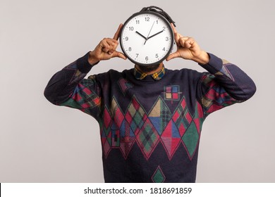 Time To Work! African Man Hiding Face Behind Big Wall Clock, Afraid Of Deadline, Wasting Time, Being Late. Indoor Studio Shot Isolated On Gray Background