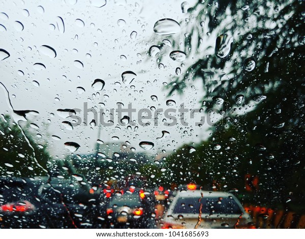 The time your car stuck\
in the jammed while raining coming down touch to your windshield\
car. Vision will blur caused rain soaked your windshield car.\
bangkok thailand.