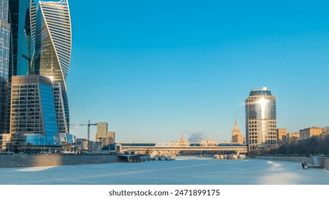 Timelapse of Moscow City and a frozen river at sunset during winter. The International Business Center, Bagration Bridge, a passing ship, and commercial district in central Moscow by the setting sun - Powered by Shutterstock