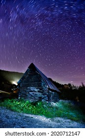 A Timelapse Shot Of The Milky Way Galaxy Over A Stone House In The Countryside