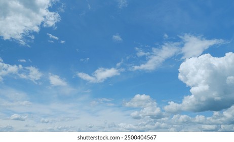Timelapse. Soft white clouds moving on blue sky background. Tropical summer or spring sunlight. Daytime.