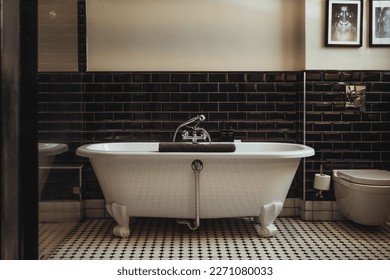 Timeless beauty with this black and white bathroom with freestanding tub and black glossy tiles. This exquisite wellness inspired interior design transforms your space into glistening elegance. 