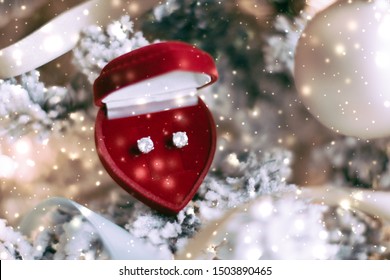 Timeless Luxury, Romantic And Happy Celebration Concept - Diamond Earrings In Heart Shaped Jewellery Gift Box On Christmas Tree, Love Present For New Years Eve, Valentines Day And Winter Holidays