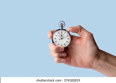 timer held in hand, blue background