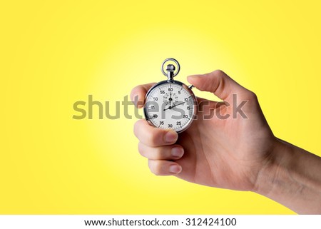 timer hold in hand, button pressed, yellow background