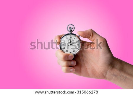 timer hold in hand, button pressed, pink background