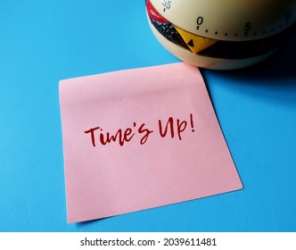 Timer on blue copy space background with note weitten TIME'S UP, concept of time running out, time management to not miss a due date or deadline, device remind a preset time