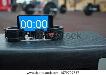 Timer on the stepper platform in the gym before the athlete starts to record video for online qualifier for international cross training competition.