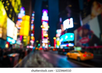 Times Square Abstract Defocus Background Night View Of Bright Lights And Traffic In Wet Winter Street Scene In New York City