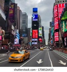 Times Square With Yellow New York City Taxi Cabs And Tour Buses Driving Through Colorful Billboards. Manhattan, New York. USA - August 25, 2015.