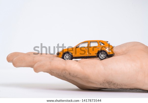 Time-worn\
car.Car (automobile) insurance and collision damage waiver\
concepts. Businessman with protective\
gesture