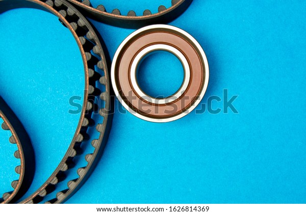 Timing belt with rollers on background .Kit of\
timing belt for car\
engine