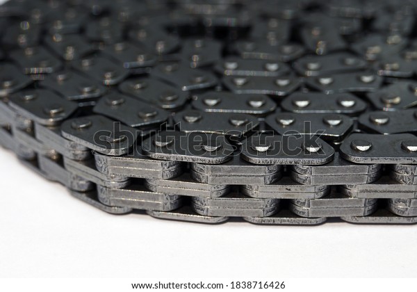 Timing chain of an engine of a modern car. Macro
photography. Individual links of the chain are in focus, the
background is blurred.