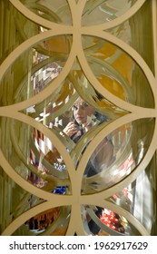 TIMISOARA, ROMANIA - October 29, 2013: Distorted Portrait Of A Brunette Woman. View Through A Glass Window 