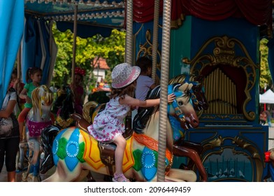 Timisoara, Romania - September 27, 2014: Young Girl Enjoying A Ride On The Merry Go Around