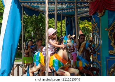 Timisoara, Romania - September 27, 2014: Young Girl Enjoying A Ride On The Merry Go Around