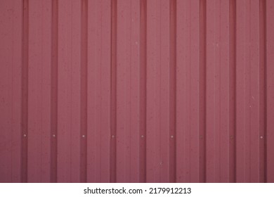 tin background burgundy red wall in metallic metal panel with worn and degraded old paint