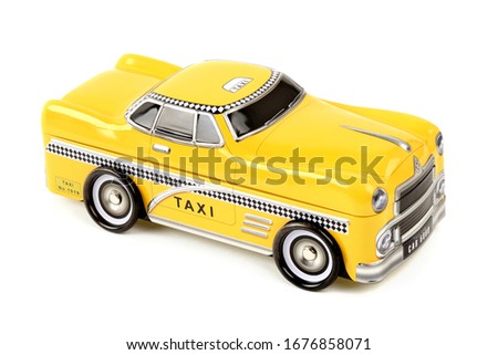 A tin box in the shape of an old yellow New York taxi cab car