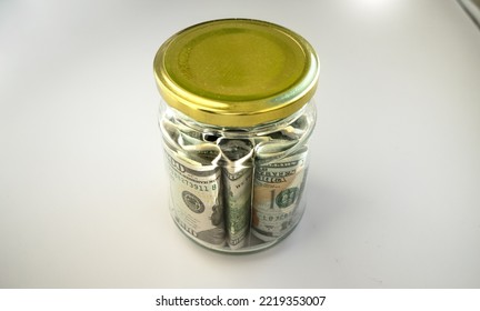 A tin can with money. A cash gift on a white background.Put the money in the bank for safekeeping.Save up for a dream. - Shutterstock ID 2219353007