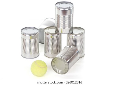 tin can pyramid with tennis ball over white - Powered by Shutterstock