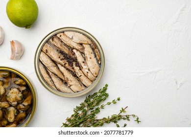 Tin can of sprats, sardines set, on white stone table background, top view flat lay, with copy space for text