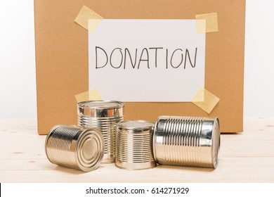 Tin Cans With Cardboard Donation Sign Donation On Wooden Table On White, Donation Concept  