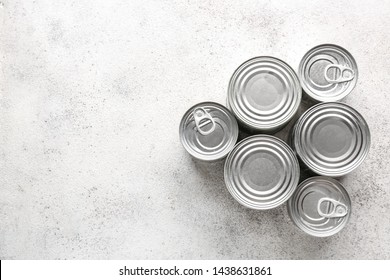 Tin Cans With Food On Grey Background