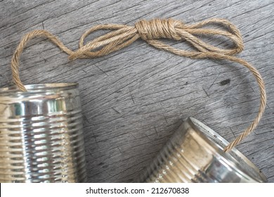 tin cans telephone on wooden background