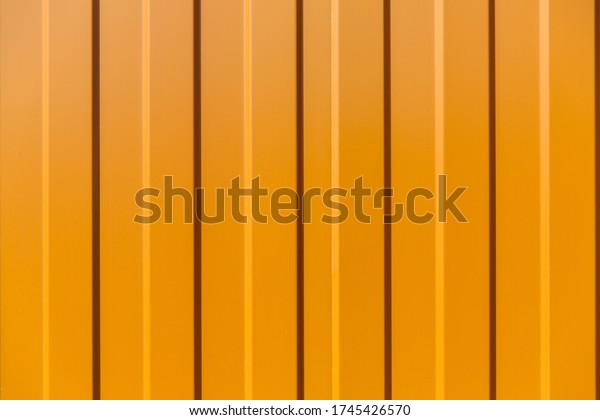 Tin fence with a beautiful textured pattern.\
Modern fence with vertical\
stripes.