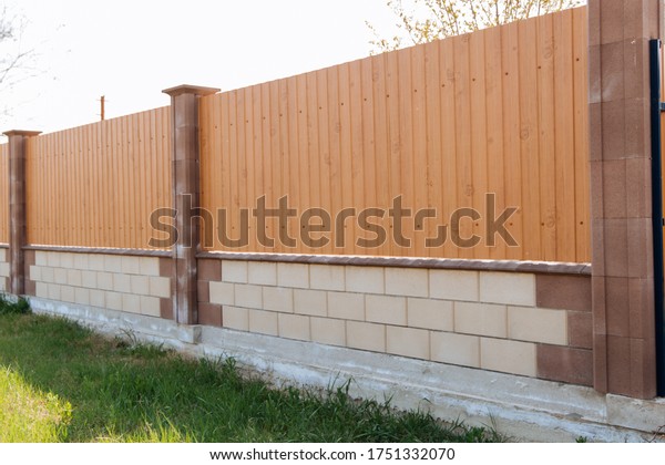 Tin fence with a beautiful textured pattern.\
Modern fence with vertical\
stripes.