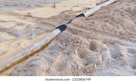 tin mining machine pipe located above the surface of muddy sand soil with mud, Bangka Belitung Island Tin Mining Area - Indonesia
