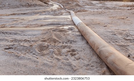 tin mining machine pipe located above the surface of muddy sand soil with mud, Bangka Belitung Island Tin Mining Area - Indonesia