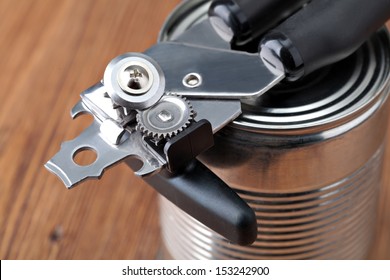 Tin opener opening a can