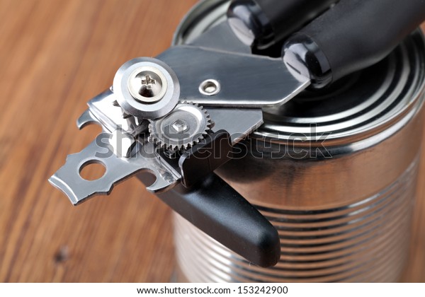 Tin opener opening a\
can
