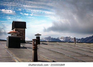 The tin roof of a mountain hut with a view to the peaks of the alps in Germany, Bavaria.
