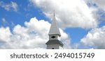 Tin roofed steeple, of the Lebanon Cumberland Presbyterian Church, near Jefferson City, Tennessee, is framed by a beautiful cloudscape.