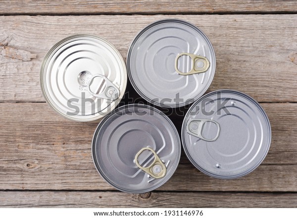 Tin\
silver cans for tinned food on wooden\
background