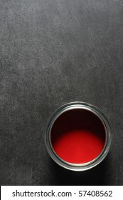 Tin Of Vibrant Red Paint On Slate Background