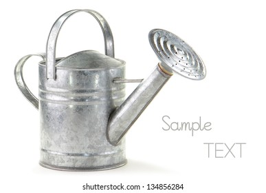 Tin watering can on white background with room for text