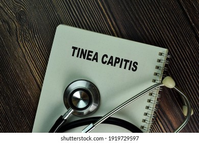 Tinea Capitis Write On A Book Isolated On Wooden Table. Medical Or Healthcare Concept