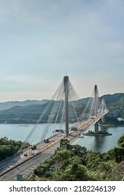  Ting Kau Bridge in Hong Kong over sea in the day with blue sky                              