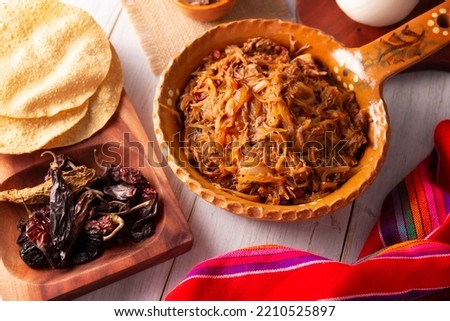 Tinga de Res. Typical Mexican dish prepared mainly with shredded beef, onion and dried chilies. It is customary to serve it on corn tortilla tostadas or tacos.