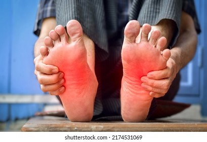 Tingling and burning sensation in feet of Asian old man with diabetes. Foot pain. Sensory neuropathy problems. Foot nerves problems. Plantar fasciitis.