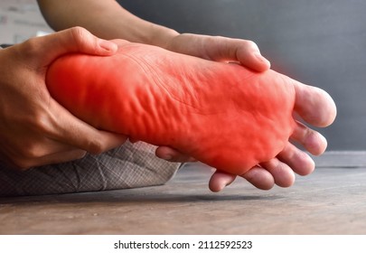 Tingling and burning sensation in foot of Asian young man with diabetes. Foot pain. Sensory neuropathy problems. Foot nerves problems. Plantar fasciitis. - Shutterstock ID 2112592523